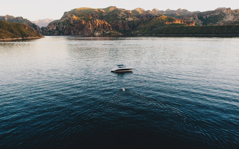 Boat on calm water near mountains