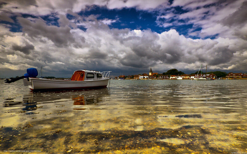 Boat on calm water under cloudy sky