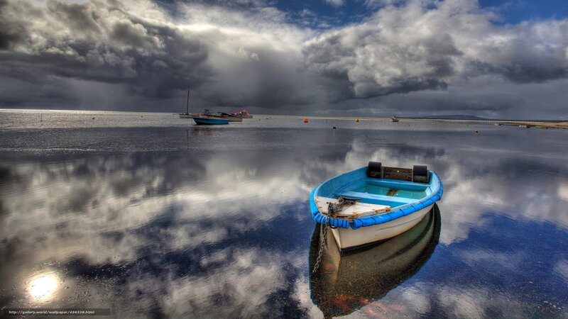 Boat on calm water under stormy sky