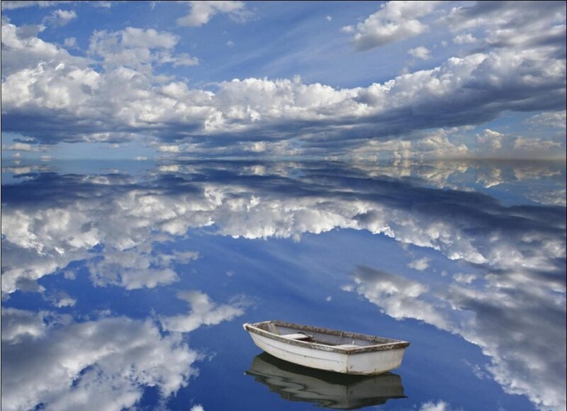 Boat on calm water with cloud reflection