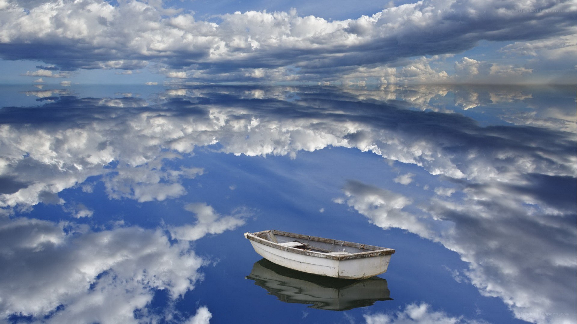Boat on calm water with cloud reflection