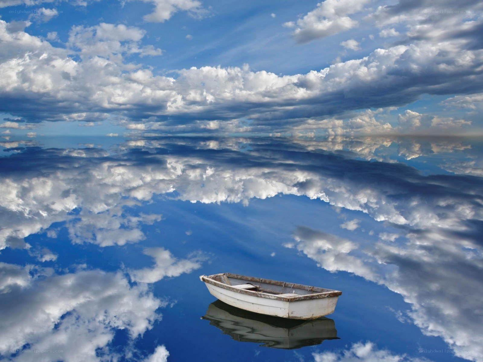 Boat on calm water with clouds