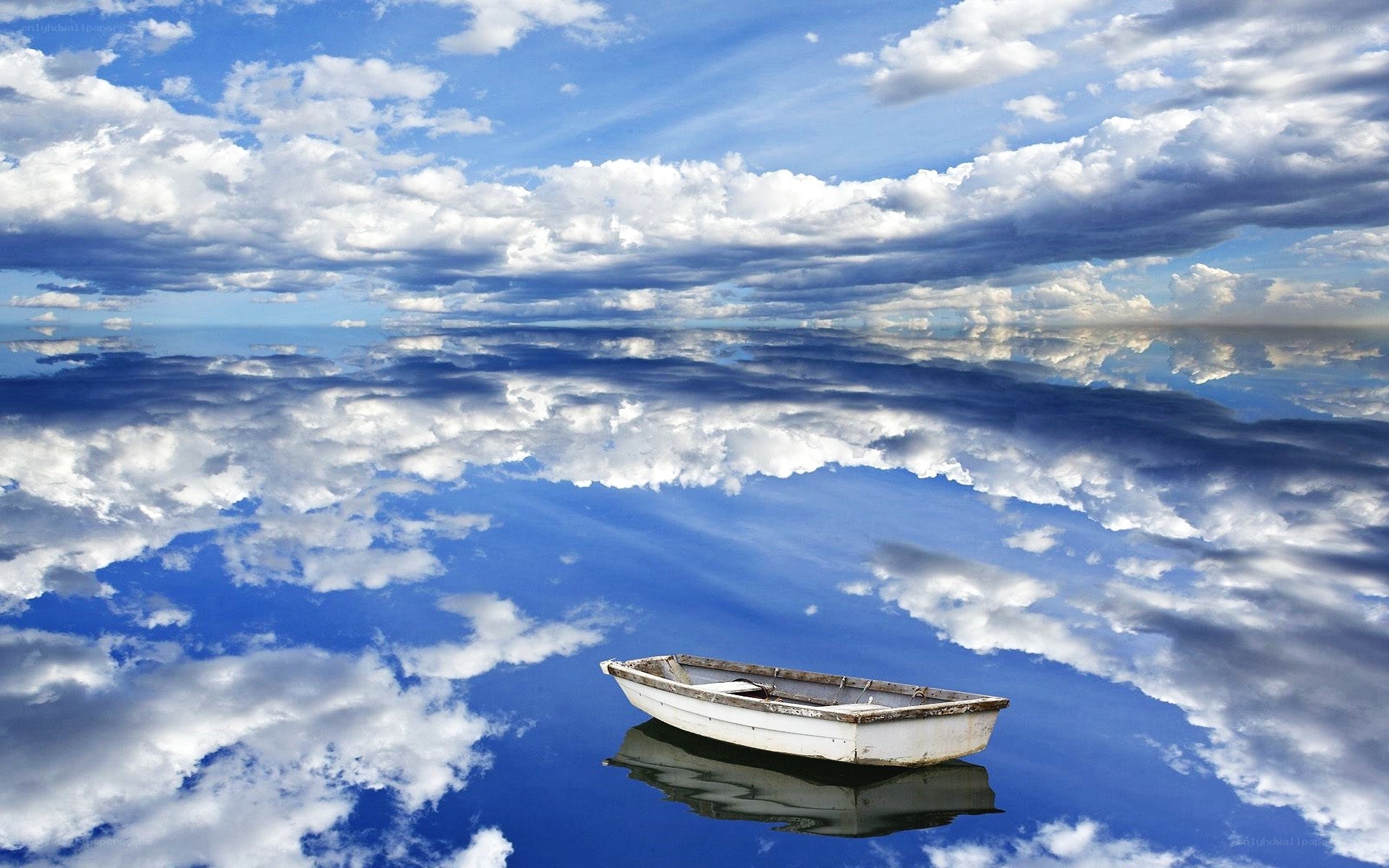 Boat on calm water with clouds
