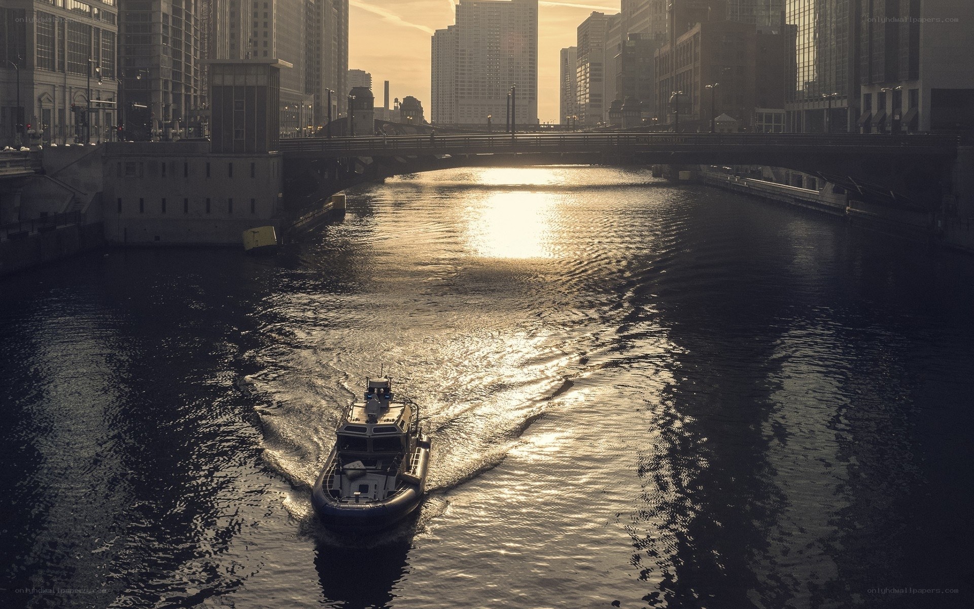 Boat on city river at sunset