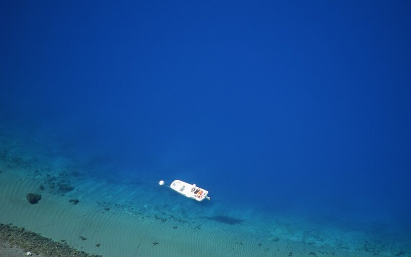 Boat on clear blue water