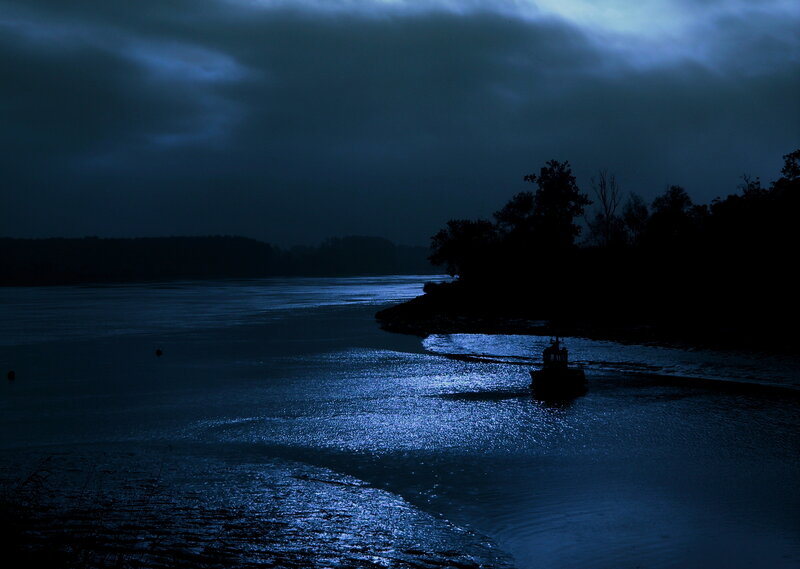 boat on dark river at night