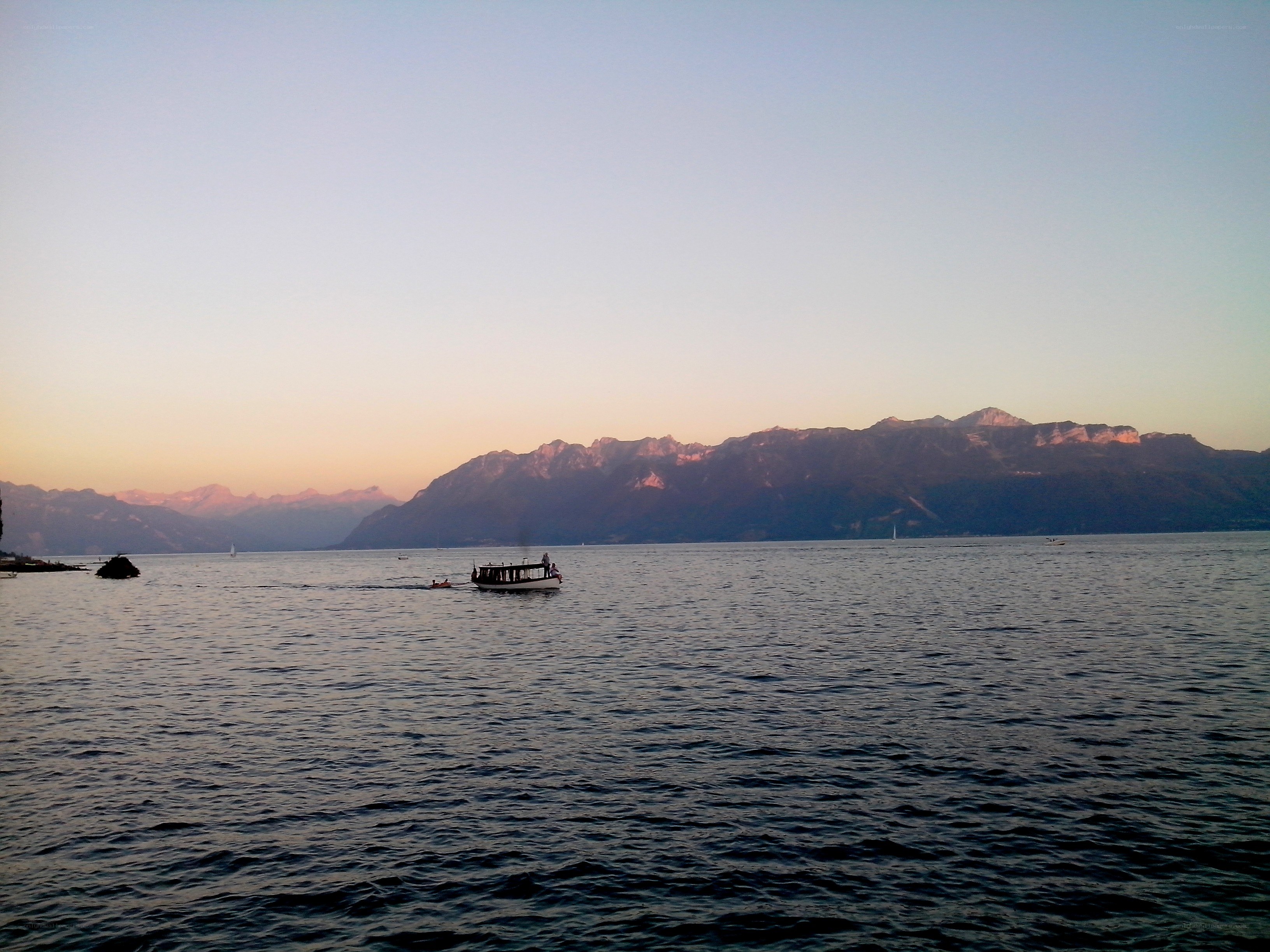 Boat on lake at sunset