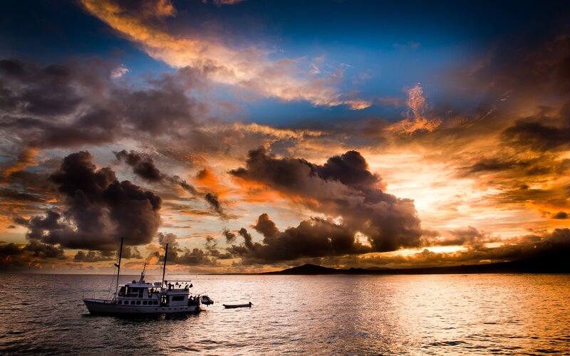 Boat on Ocean at Sunset — Blue, Dramatic