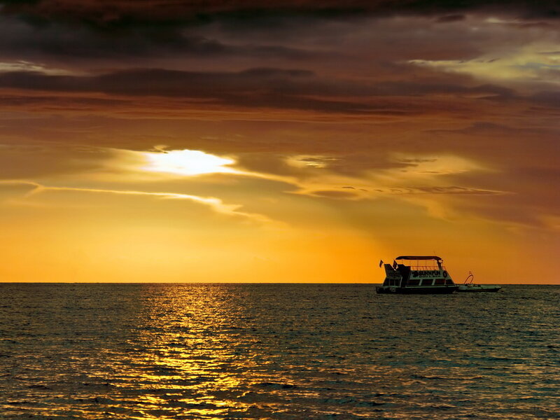 Boat on Ocean at Sunset — Orange, Serene