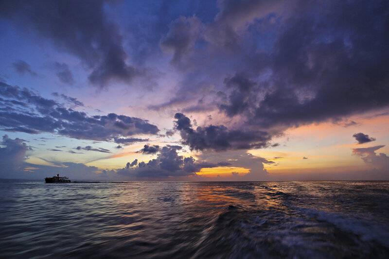 Boat on Ocean at Sunset — Purple