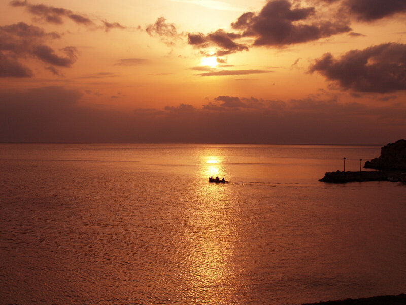 Boat on Ocean at Sunset