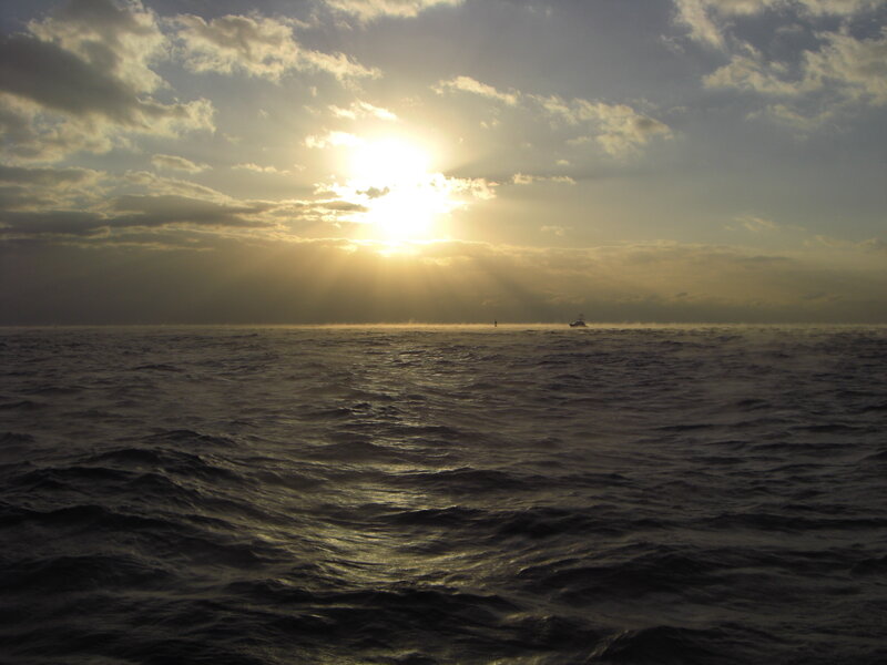 Boat on Ocean at Sunset — Yellow, Dramatic, Photograph
