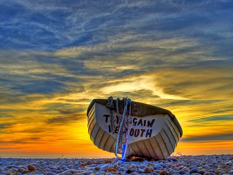 Boat on Pebble Beach — Blue, Dramatic, Sunset, Photograph, Sky