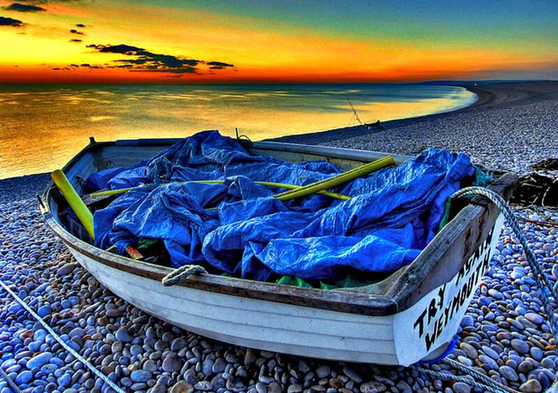Boat on Pebble Beach — Blue, Dramatic