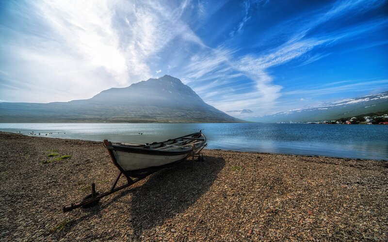 Boat on Pebble Beach — Blue, Serene, Afternoon