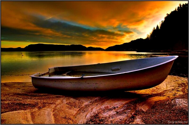 Boat on shore at sunset