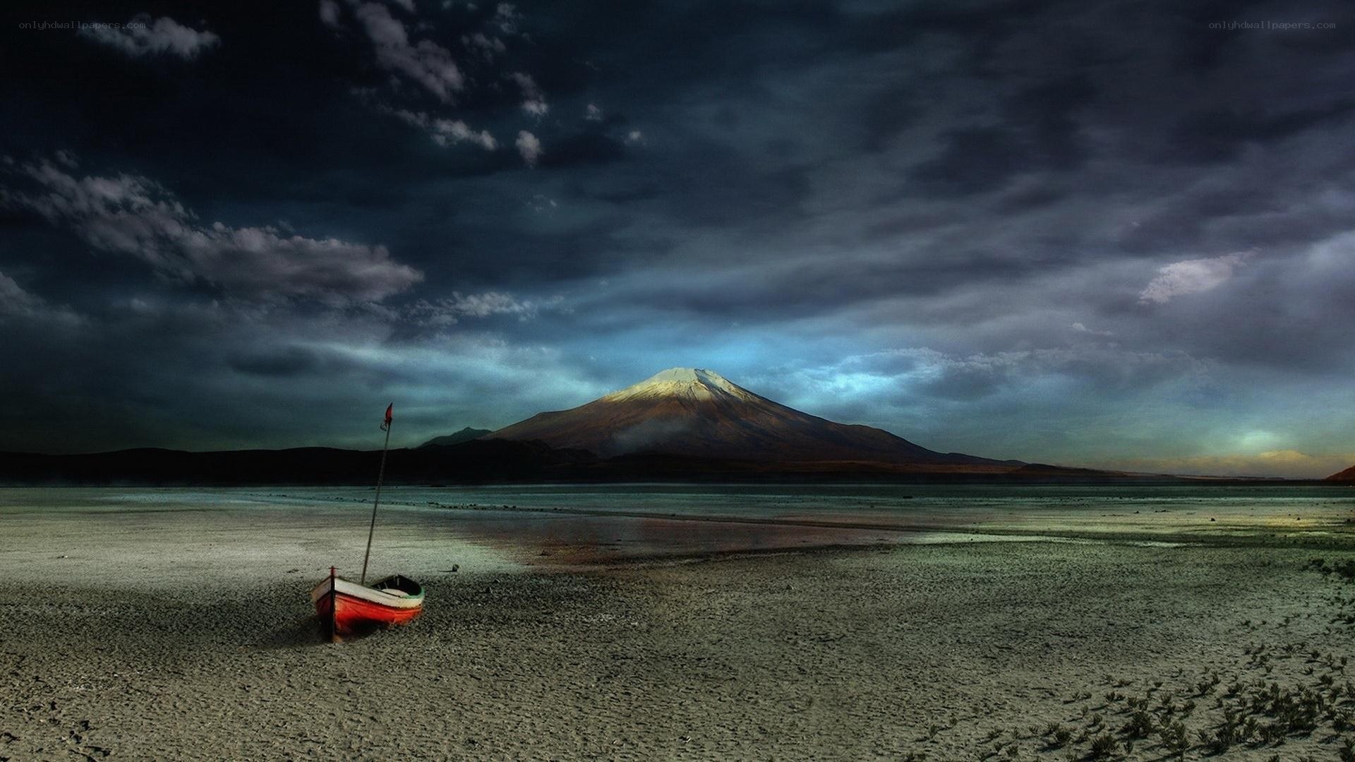 Boat on shore with mountain