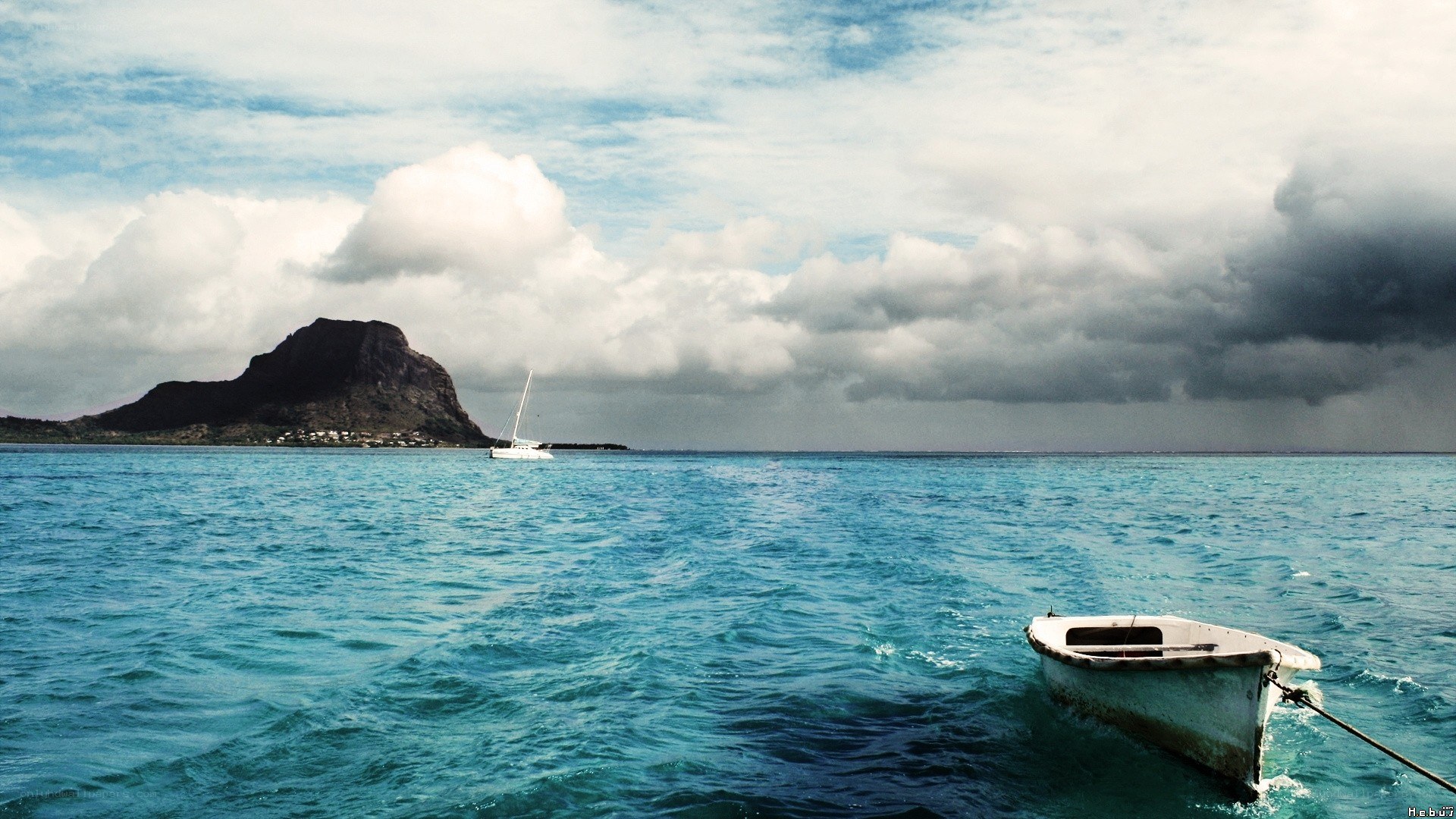 Boat on the ocean with a mountain