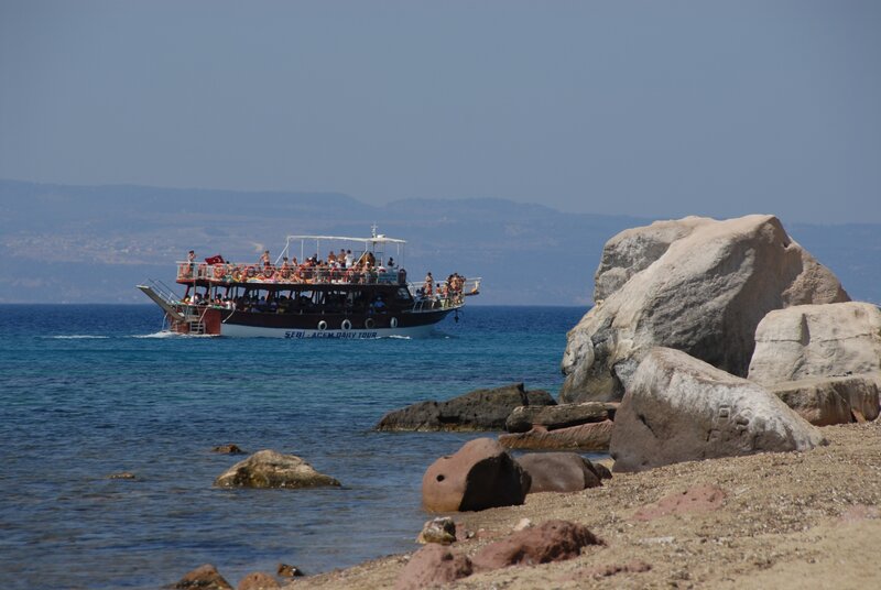 Boat tour near rocky shore