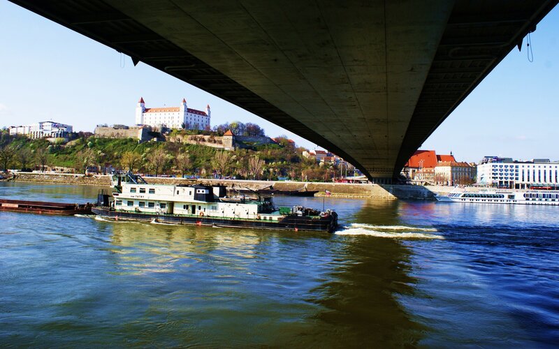 Boat under a bridge with castle