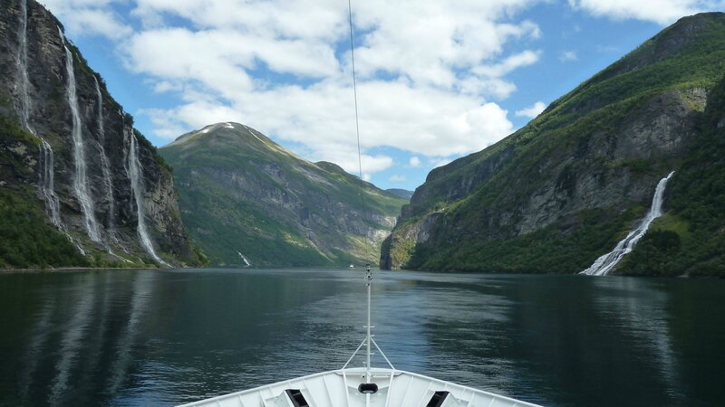 boat view of fjord with waterfalls