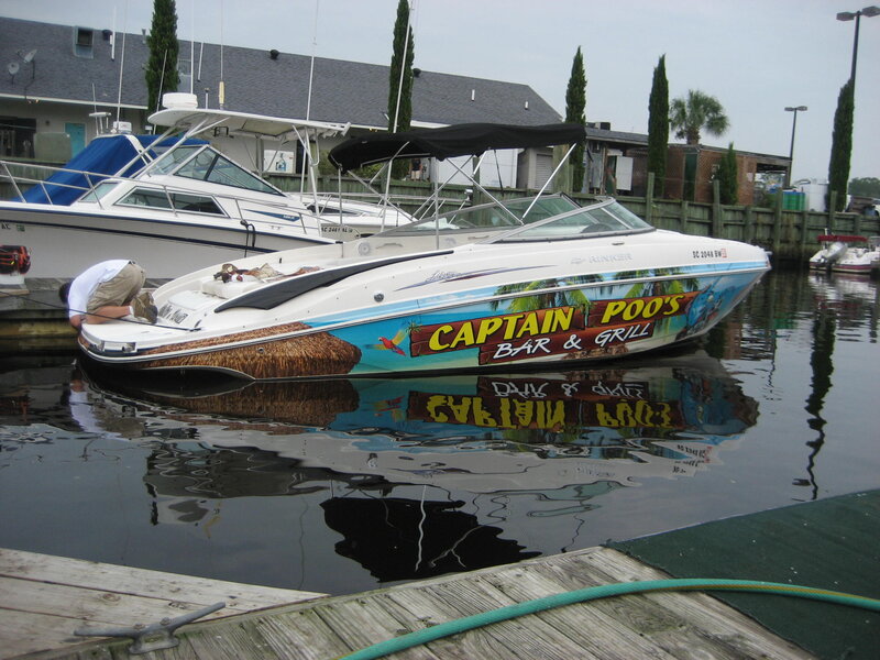 Boat with Captain Poo's Sign