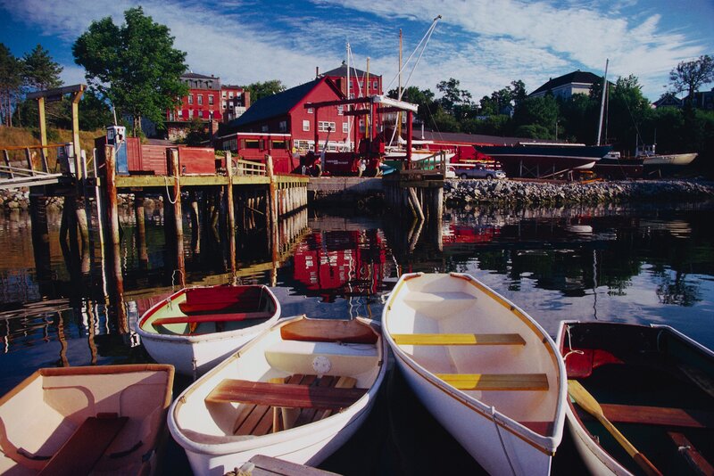 Boats at a harbor with red buildings