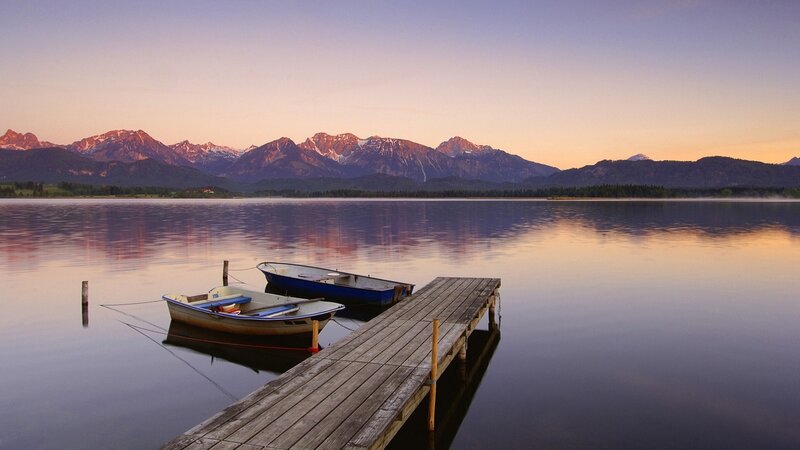 Boats at a lake with mountains