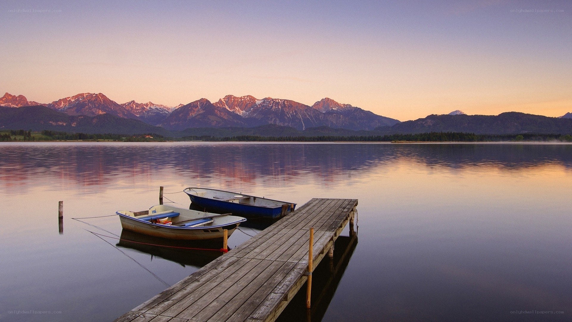 Boats at a lake with mountains