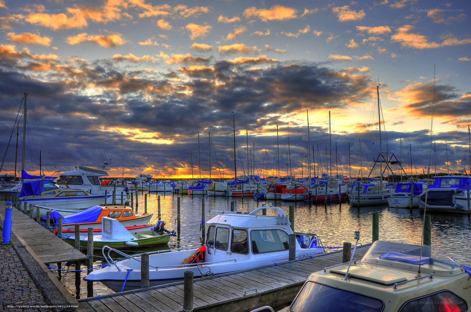 Boats at a marina during sunset