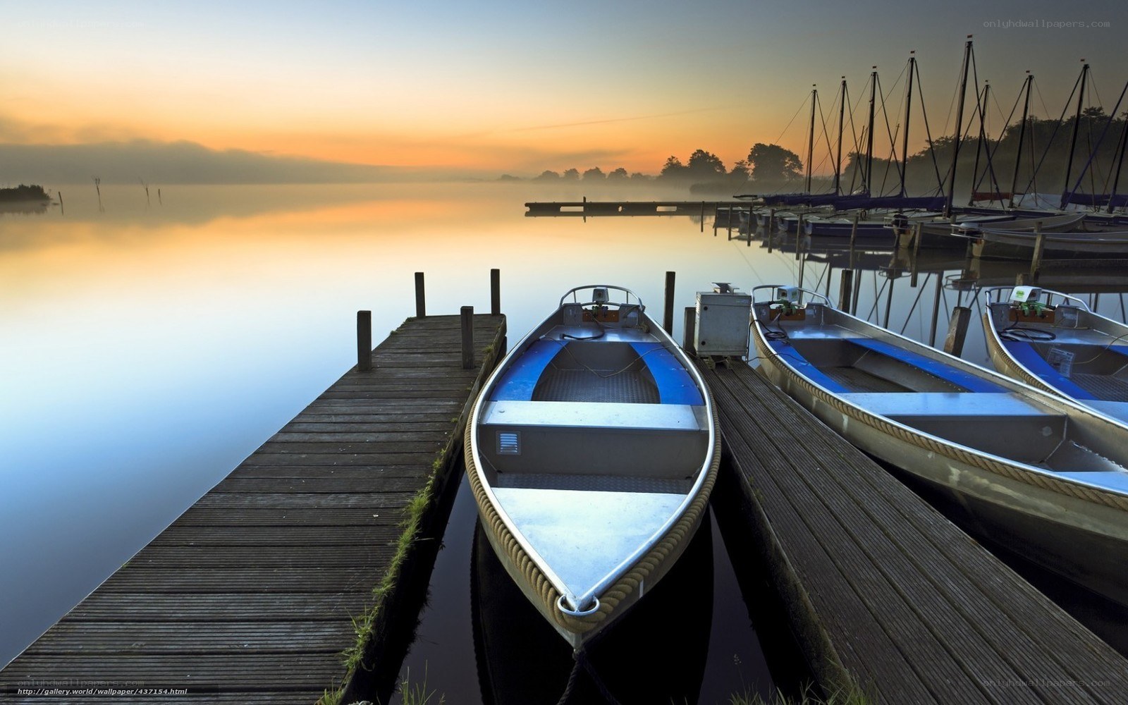 Boats at dawn on a calm lake