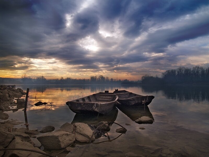 Boats at dusk on a calm lake
