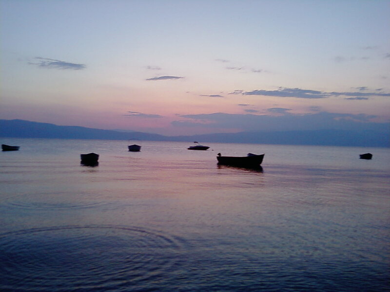 Boats at dusk on a calm lake