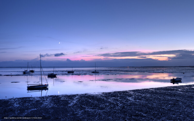Boats at dusk on a calm shore