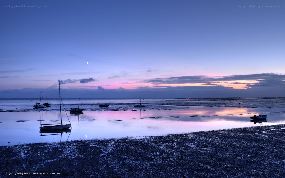 Boats at dusk on a calm shore