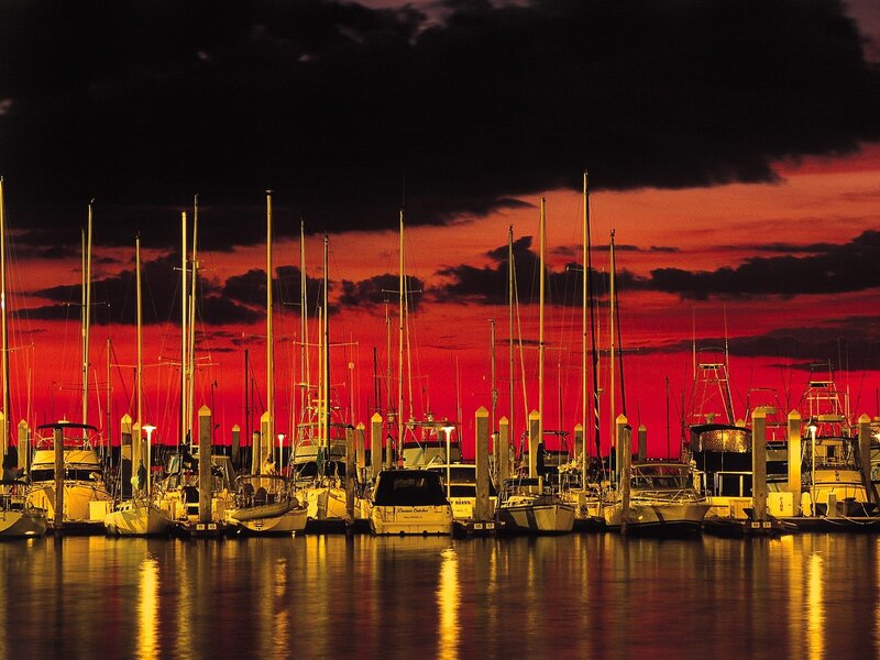 Boats at marina during sunset