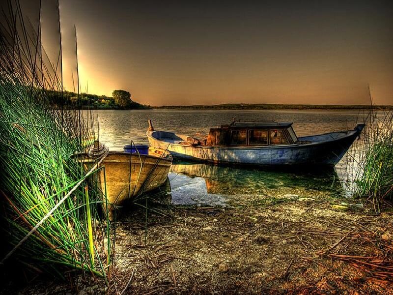 Boats at sunset on a calm lake