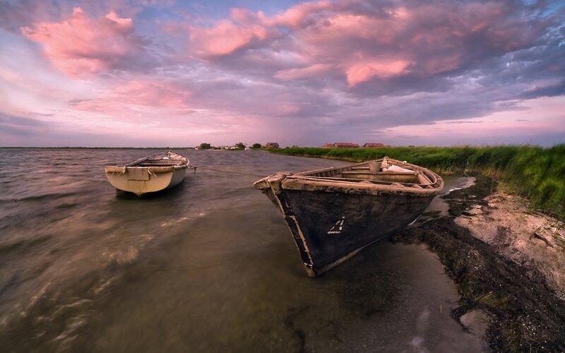 Boats at sunset on a calm shore