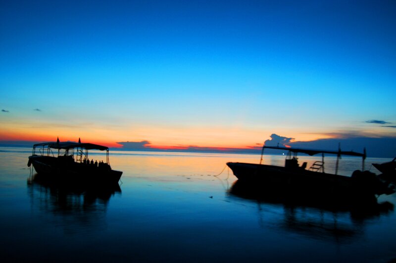 Boats at sunset on calm water