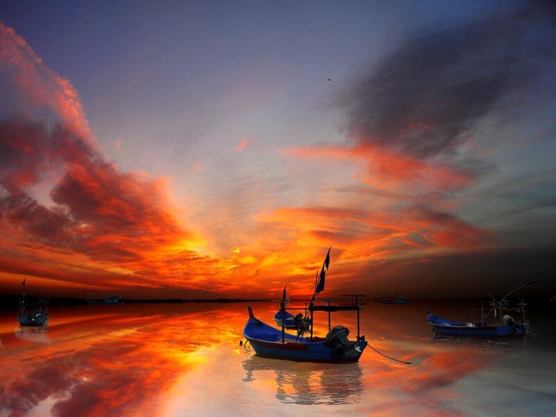 Boats at sunset on calm water