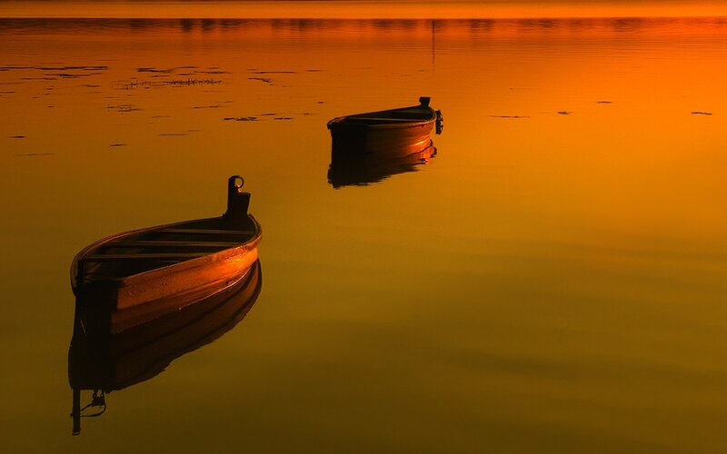 Boats at sunset on calm water