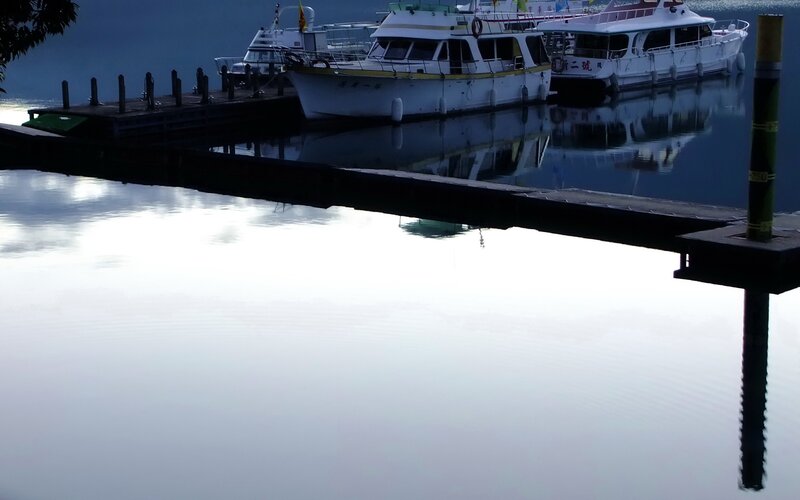 Boats docked at a calm marina