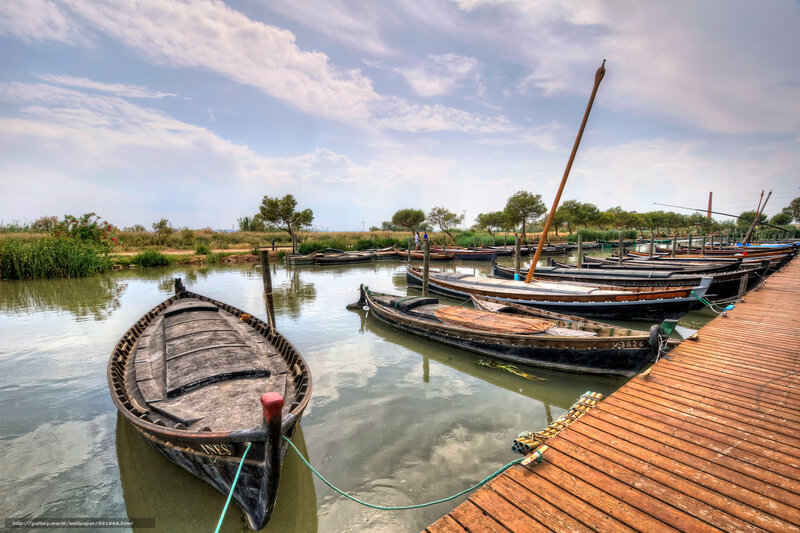 Boats docked at a wooden pier
