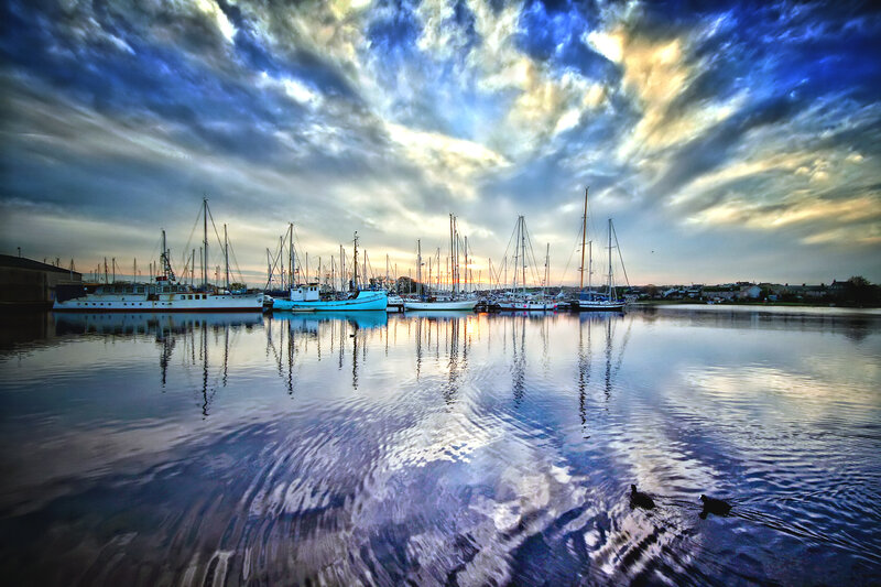 Boats docked at sunset