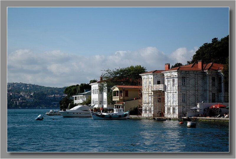Boats docked by waterfront houses