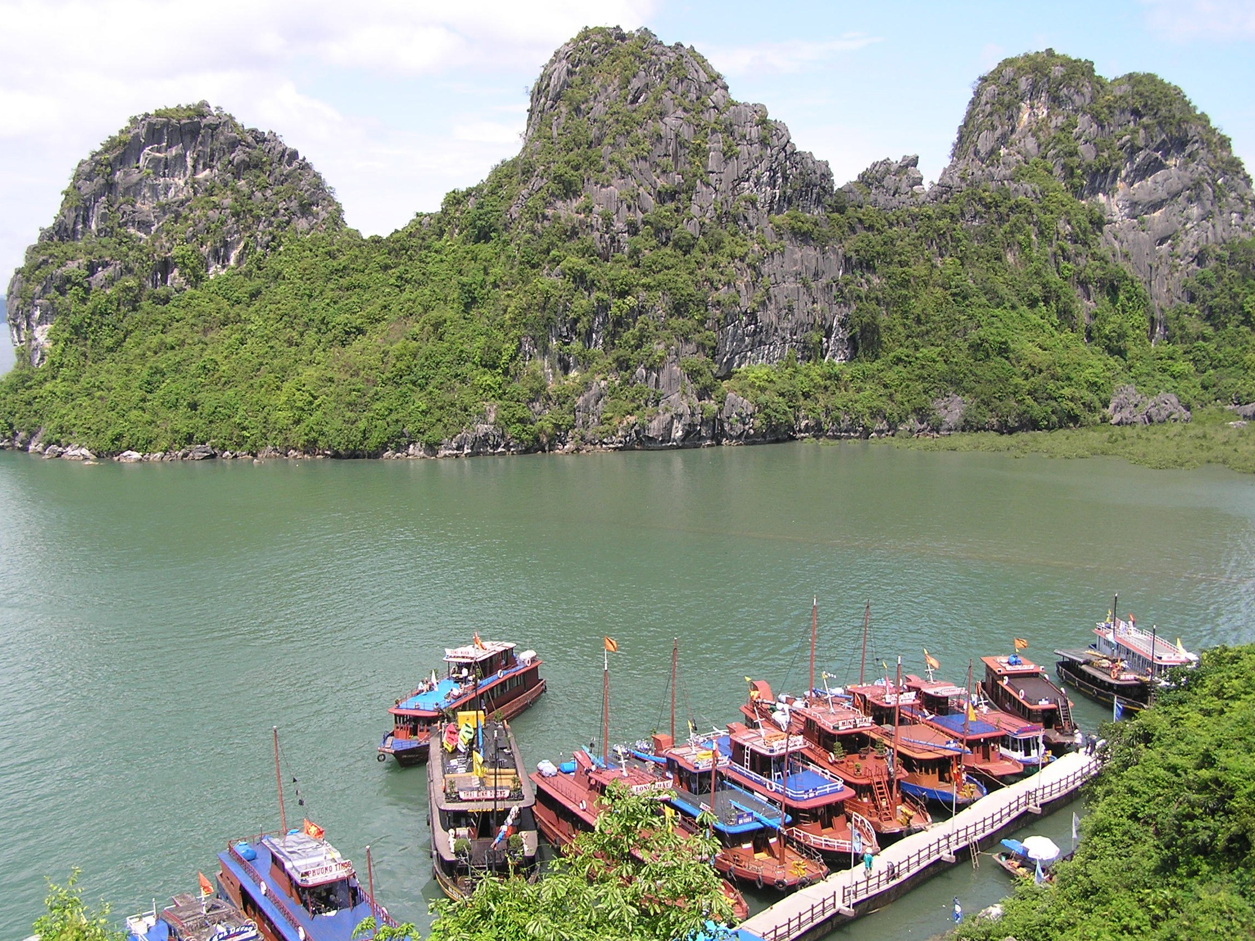 Boats docked near limestone cliffs