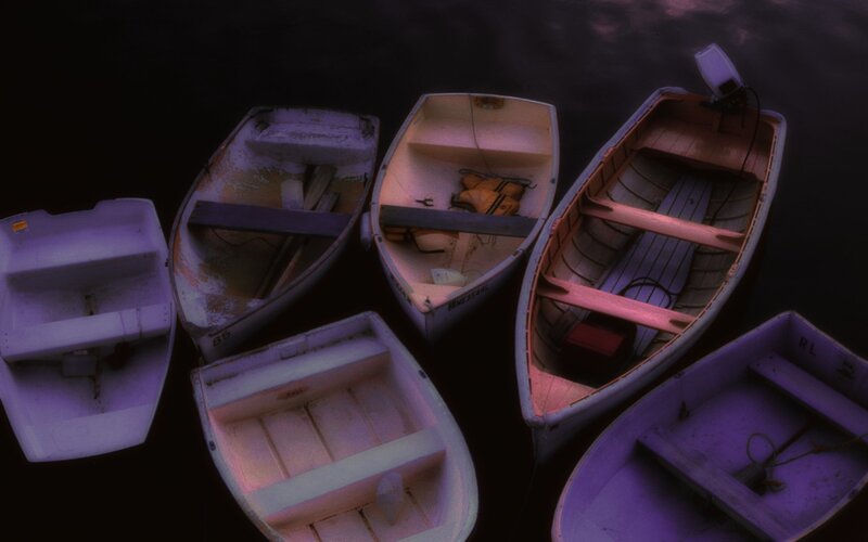 Boats floating on dark water