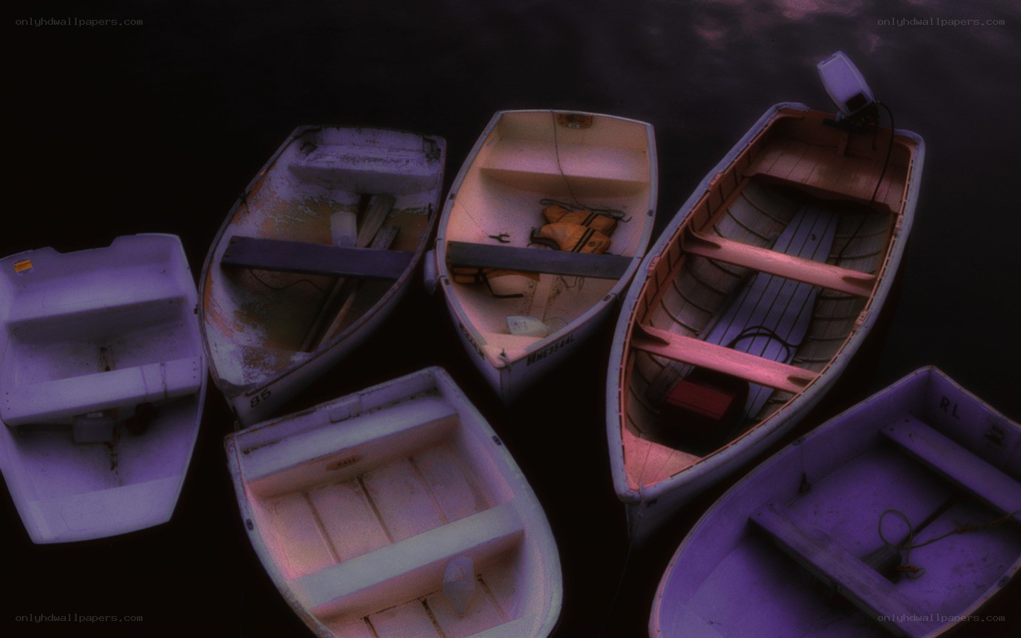 Boats floating on dark water