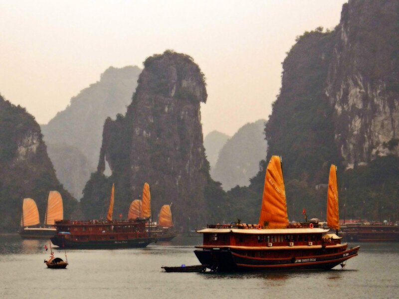 Boats in a bay with karst mountains