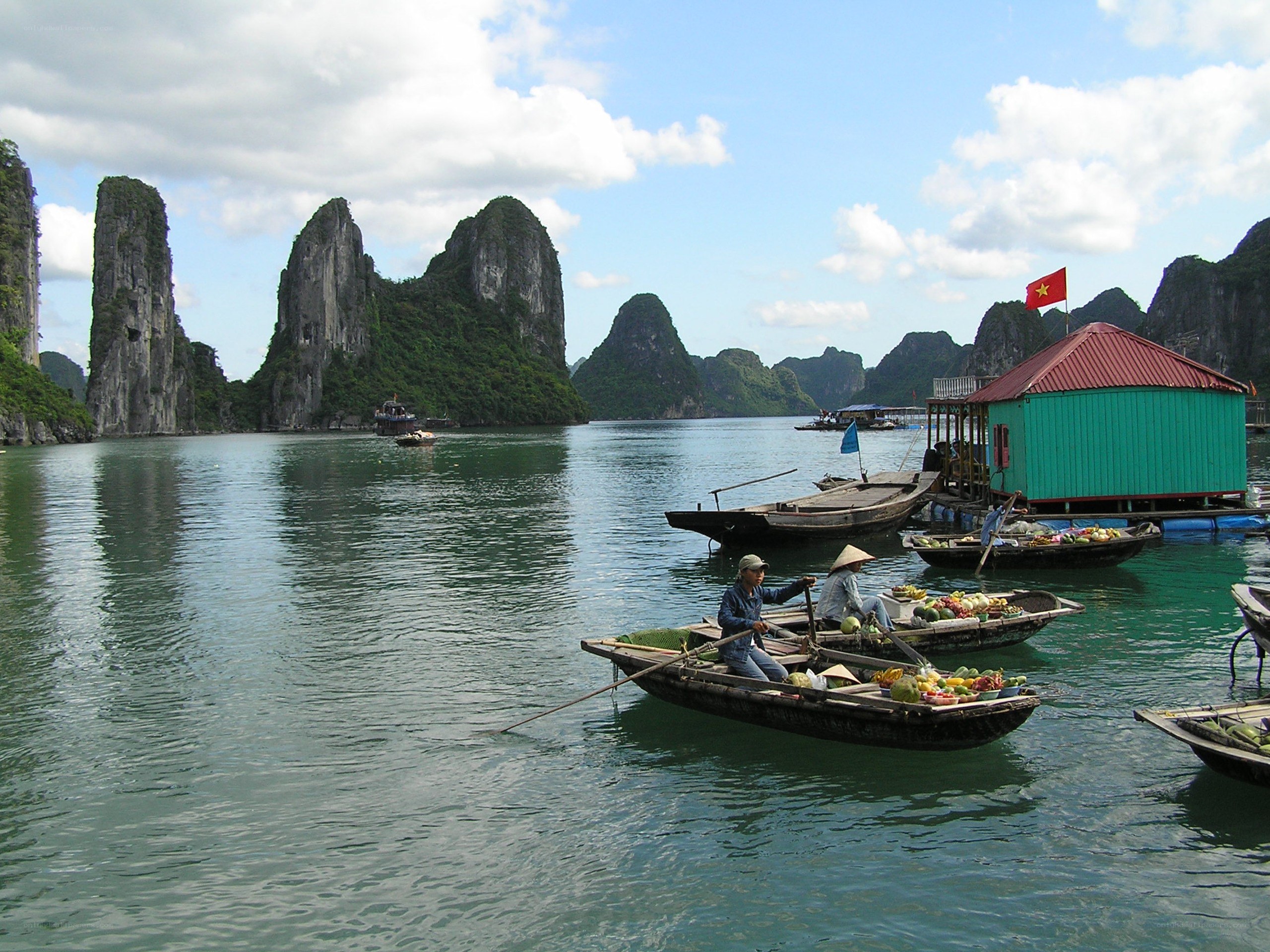 Boats in a bay with limestone cliffs